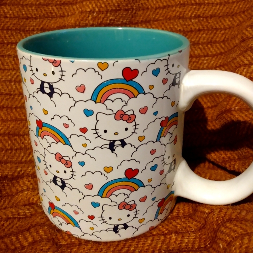 Hello kitty rainbow cup. 20 ounces. Like new condition used. Teal and white.